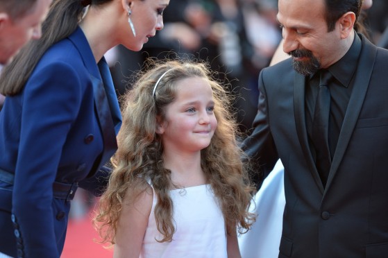 Argentinian-born French actress Berenice Bejo (L) and Iranian director Asghar Farhadi (R) talk on May 17, 2013 to French actress Jeanne Jestin as they arrive for the screening of the film "The Past" presented in Competition at the 66th edition of the Cannes Film Festival in Cannes. Cannes, one of the world's top film festivals, opened on May 15 and will climax on May 26 with awards selected by a jury headed this year by Hollywood legend Steven Spielberg. AFP PHOTO / ALBERTO PIZZOLI (Photo credit should read ALBERTO PIZZOLI/AFP/Getty Images)